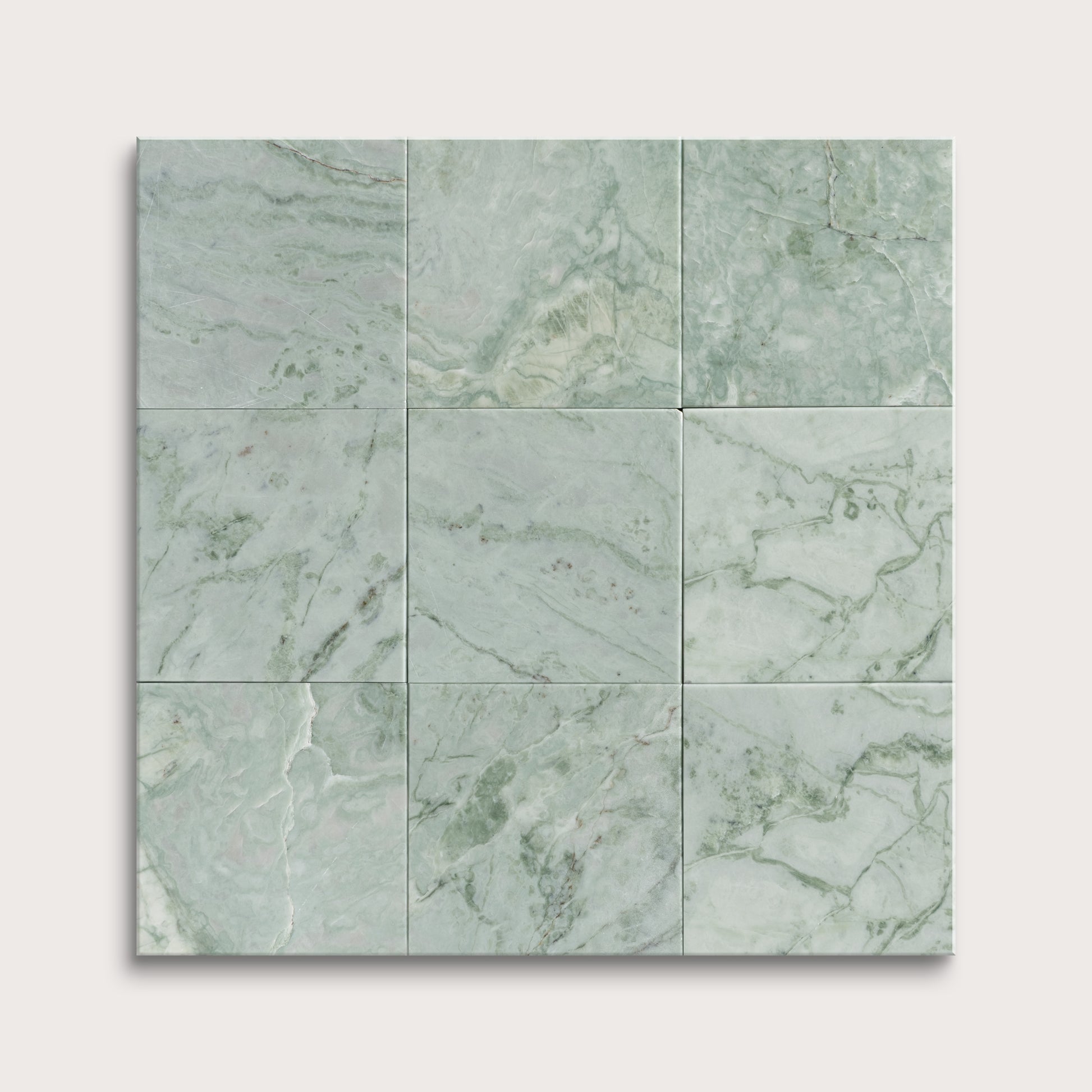 Green marble tiles arranged in a grid pattern on a white background