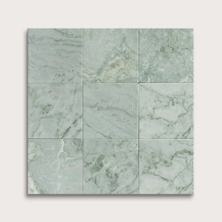 Green marble tiles arranged in a grid pattern on a white background