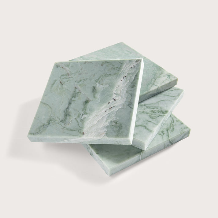 Green marble-patterned tile stacked on a white background