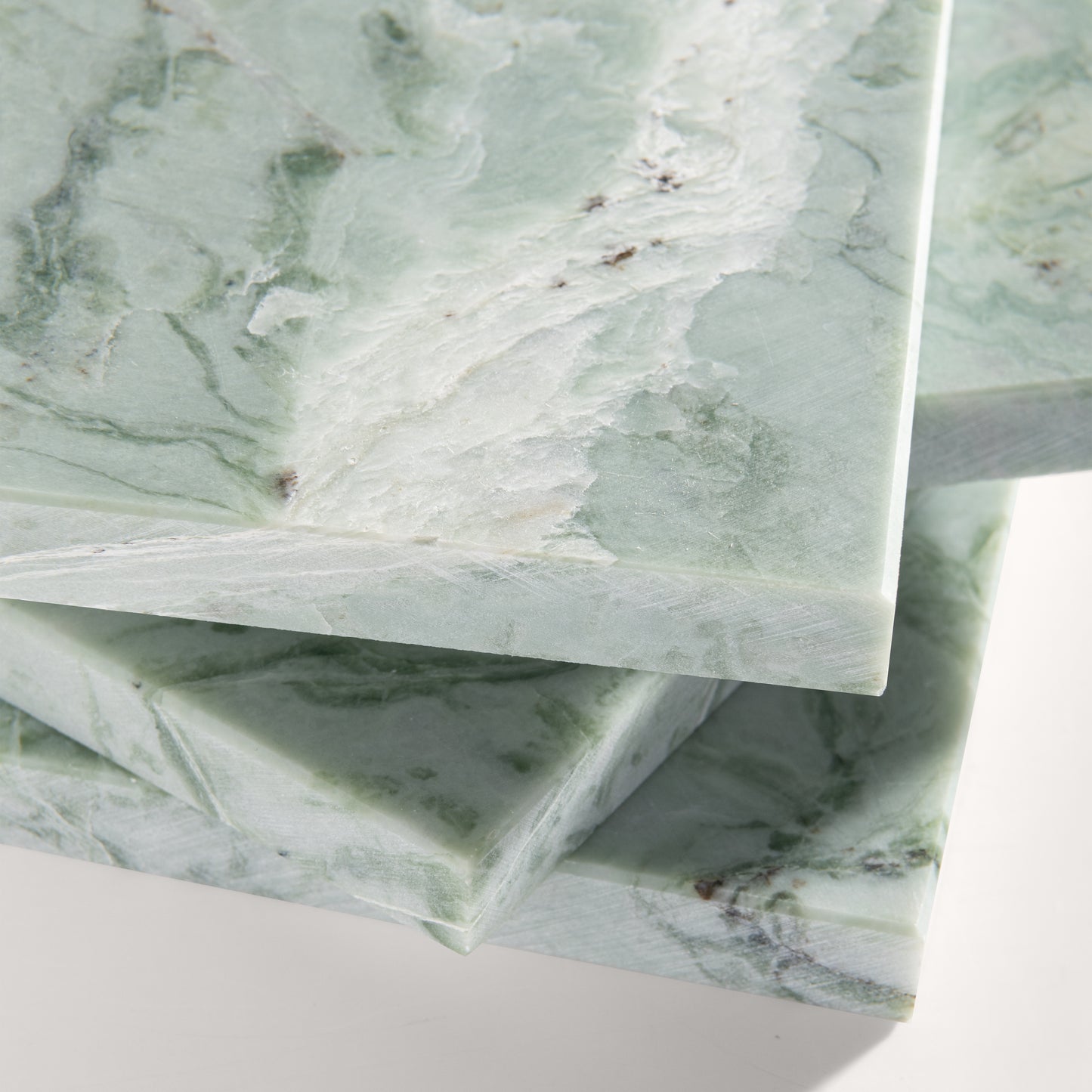 close up of Green marble-patterned tile on a white background
