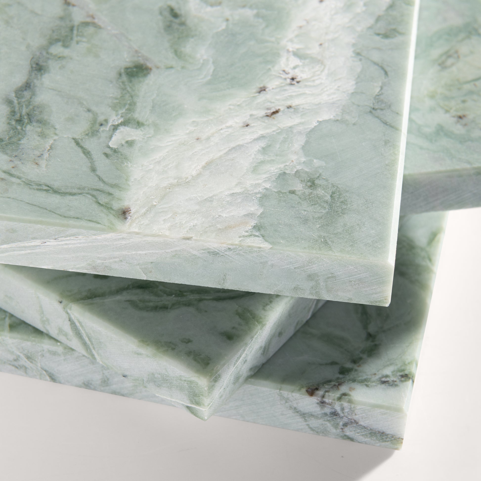 close up of Green marble-patterned tile on a white background