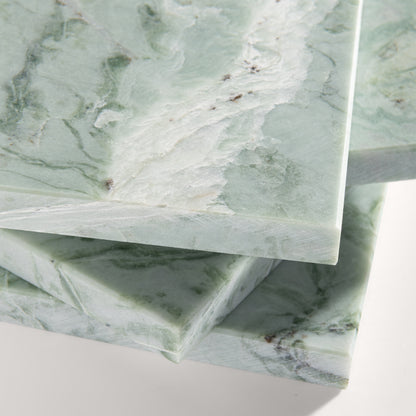 close up of Green marble-patterned tile on a white background
