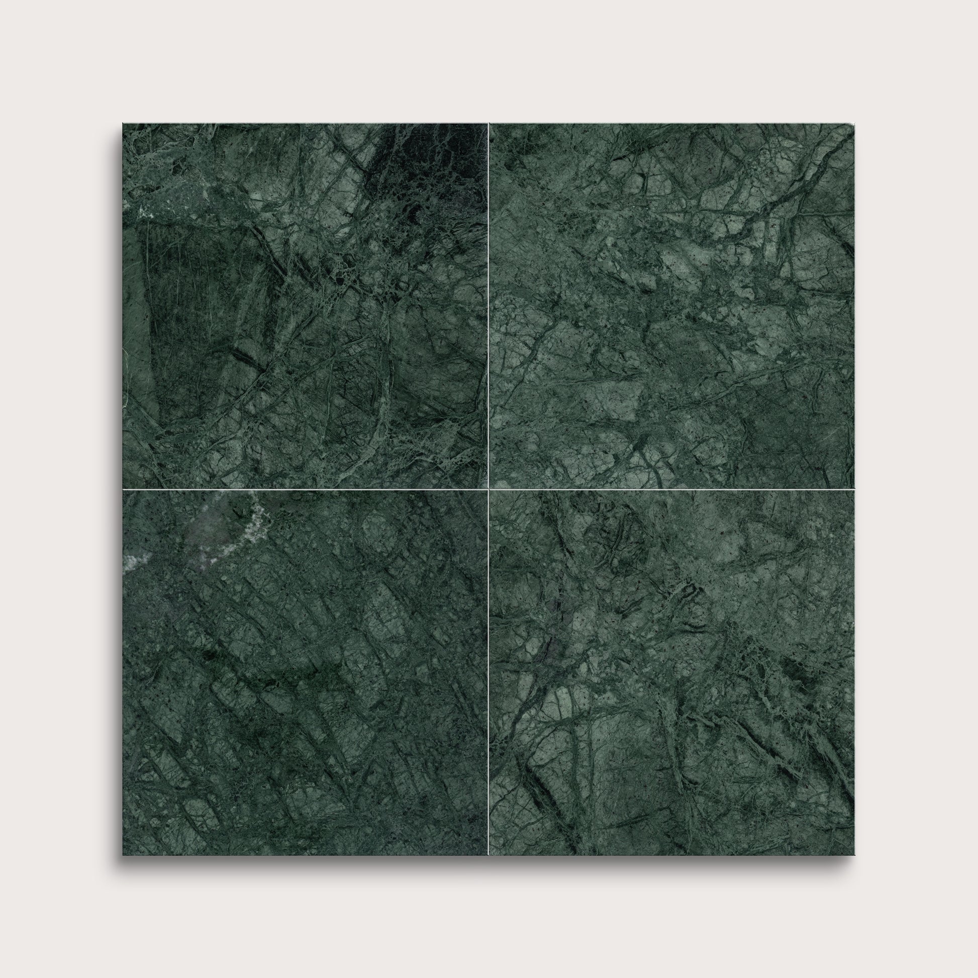 Four green marble tiles arranged in a grid on a light gray background