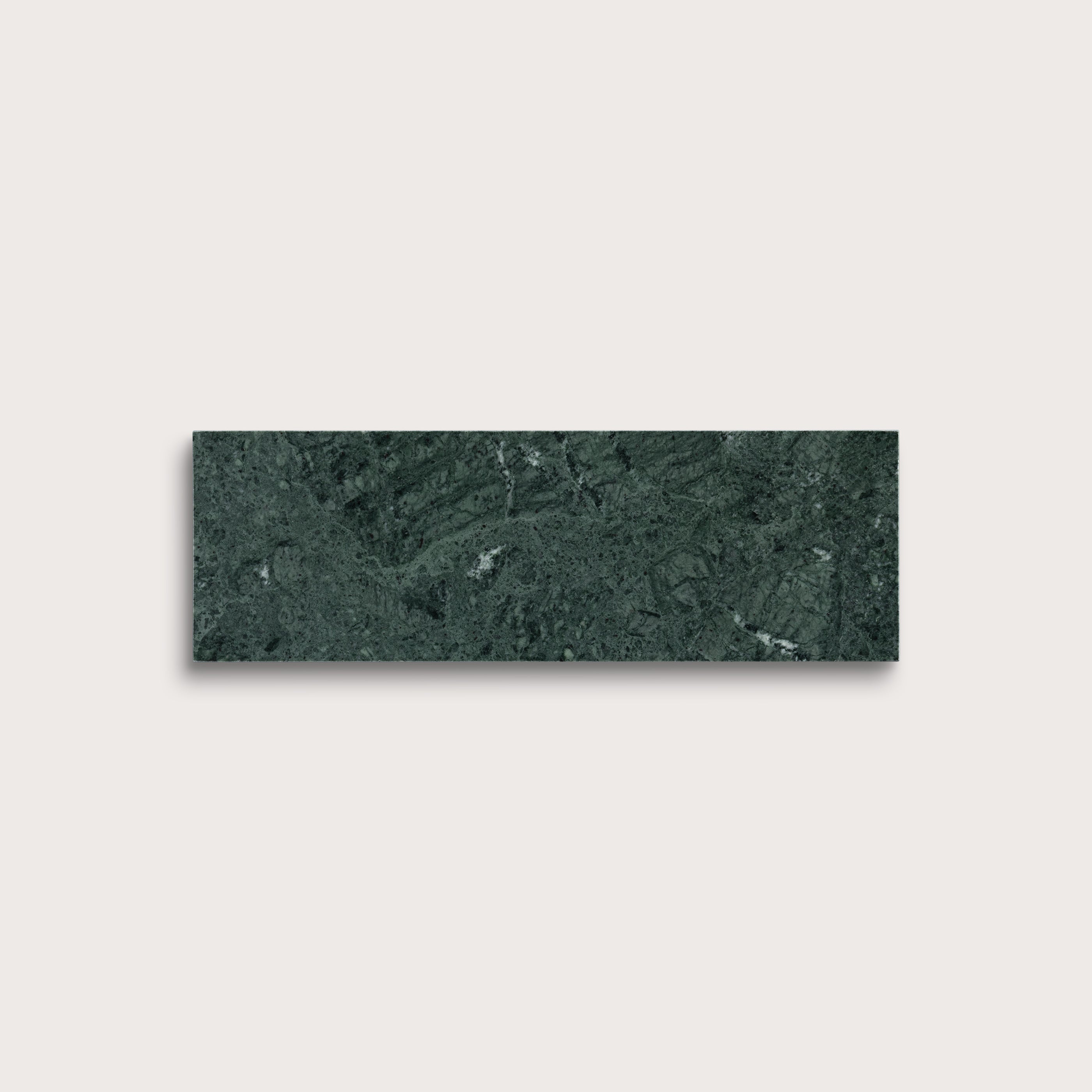 Green marble tile on a light gray background