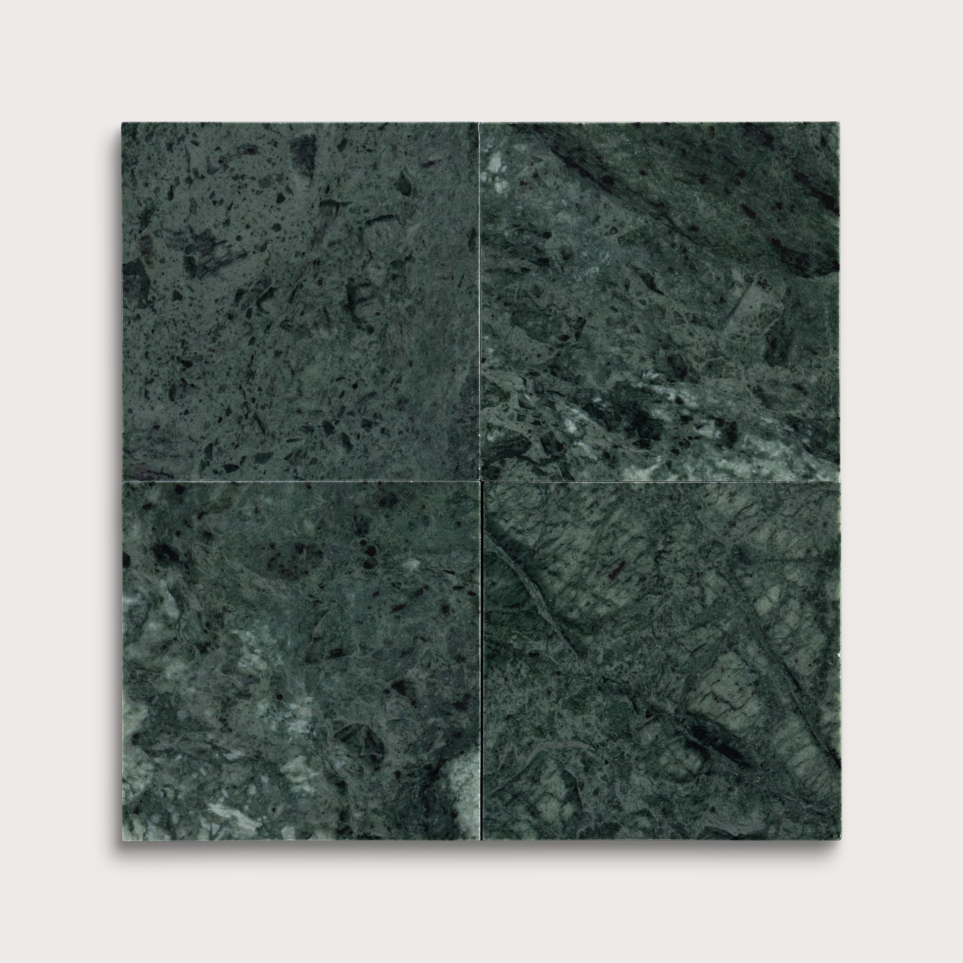Four square tiles with a dark green marble pattern on a white background