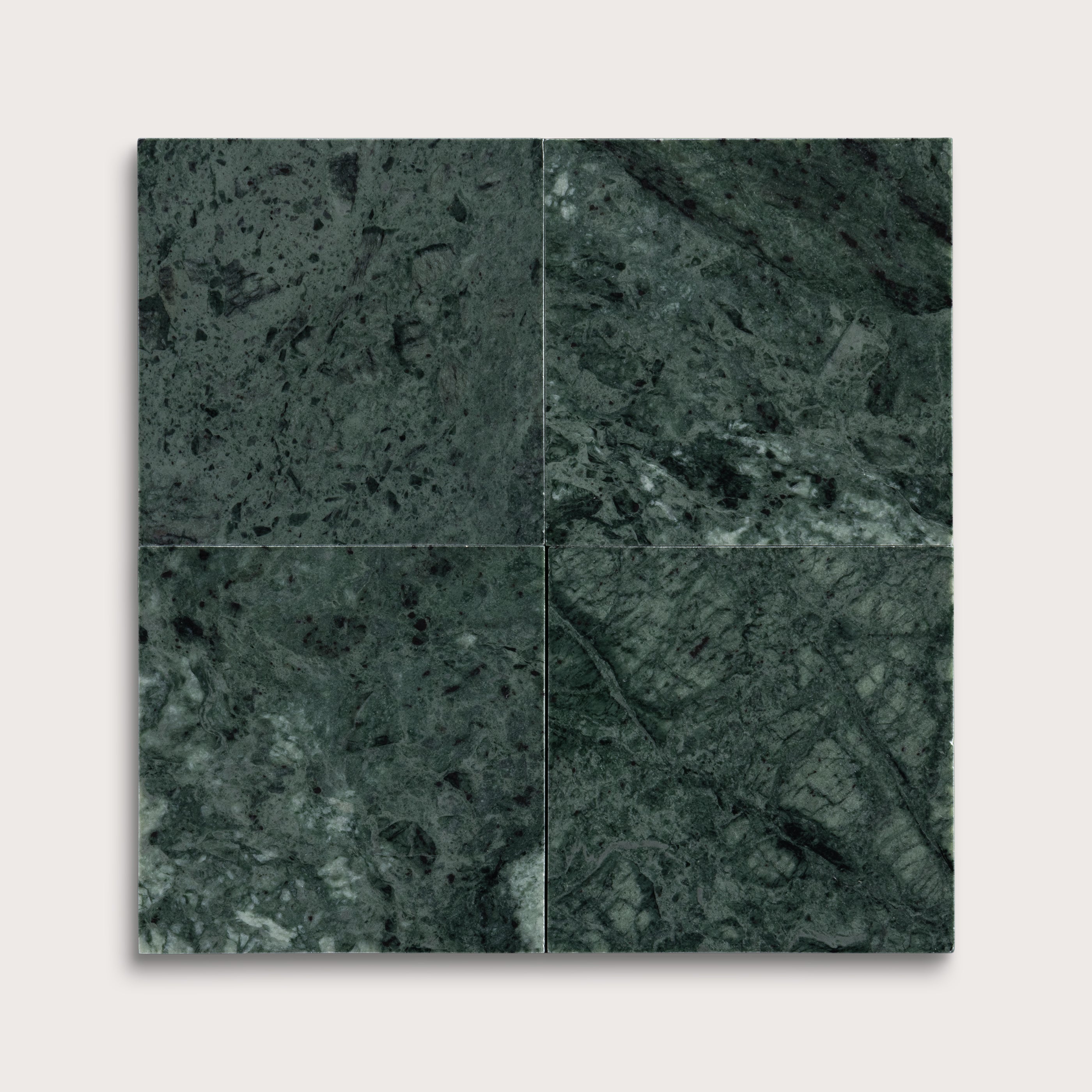 Four square tiles with a dark green marble pattern on a white background