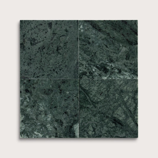 Four square tiles with a dark green marble pattern on a white background