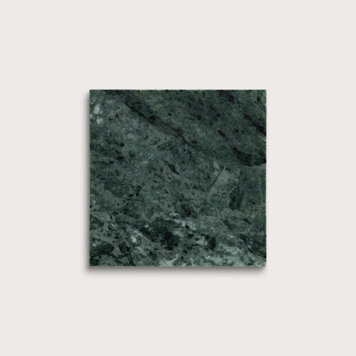 Square tile with a green marble pattern on a light gray background