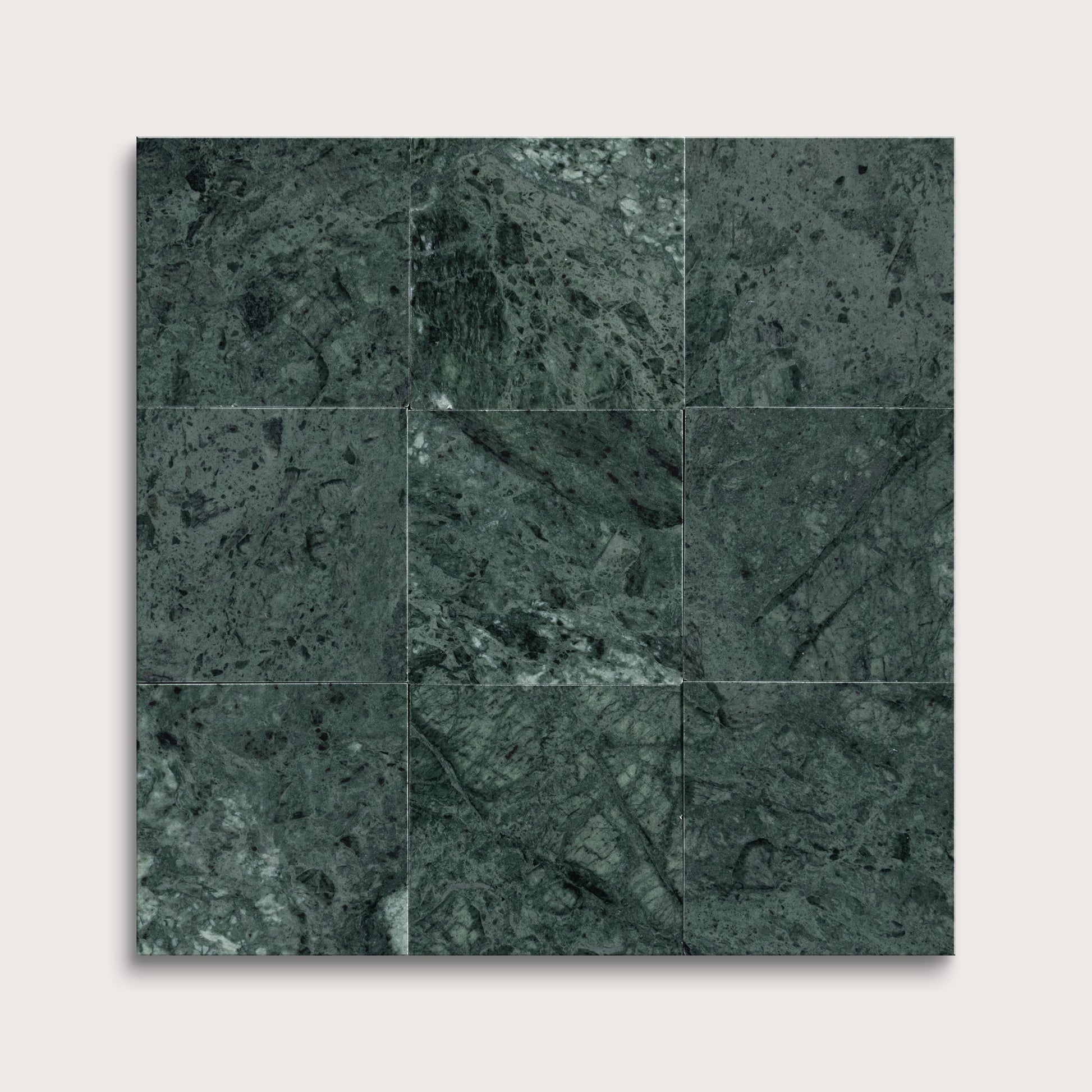 Dark green marble tiles arranged in a grid pattern on a white background