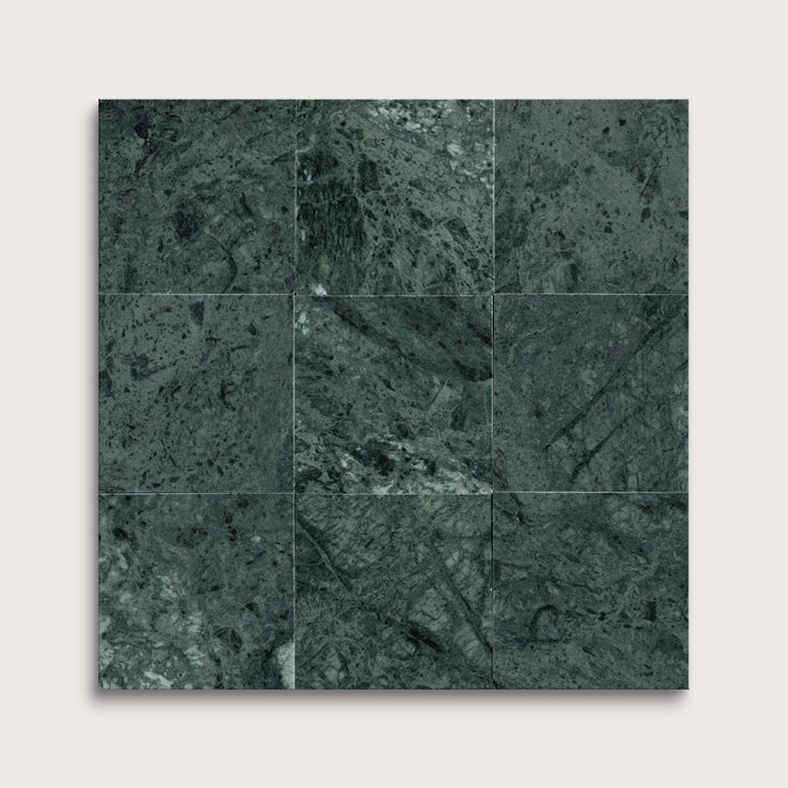 Dark green marble tiles arranged in a grid pattern on a white background
