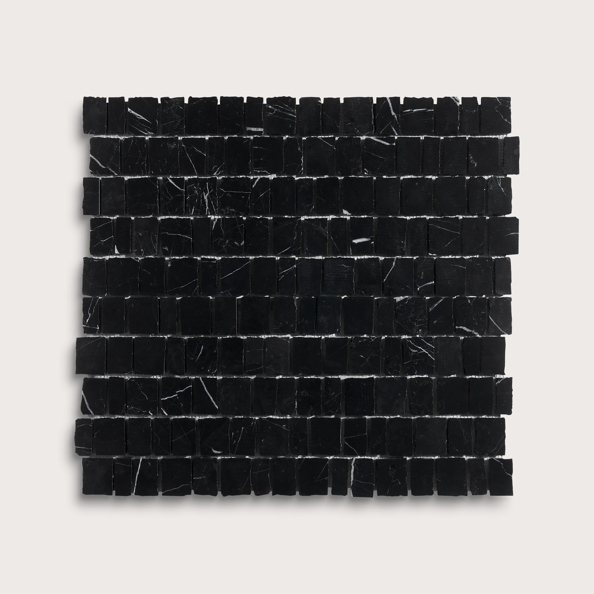 A square sample of black marble mosaic tiles with natural white veining, arranged in a grid pattern against a light gray background.