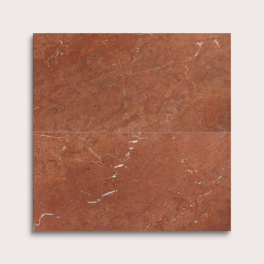 Brown marble tile with visible veins on a white background