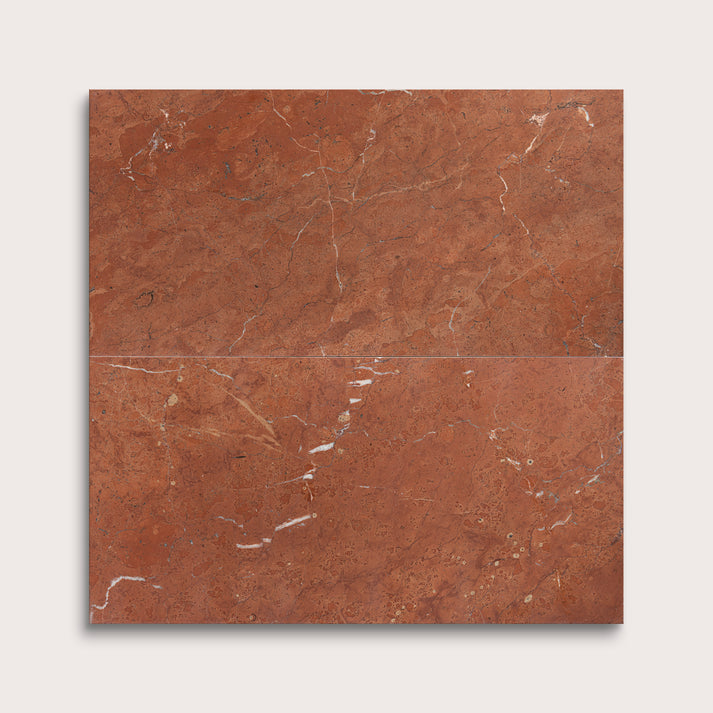 Brown marble tile with visible veins on a white background
