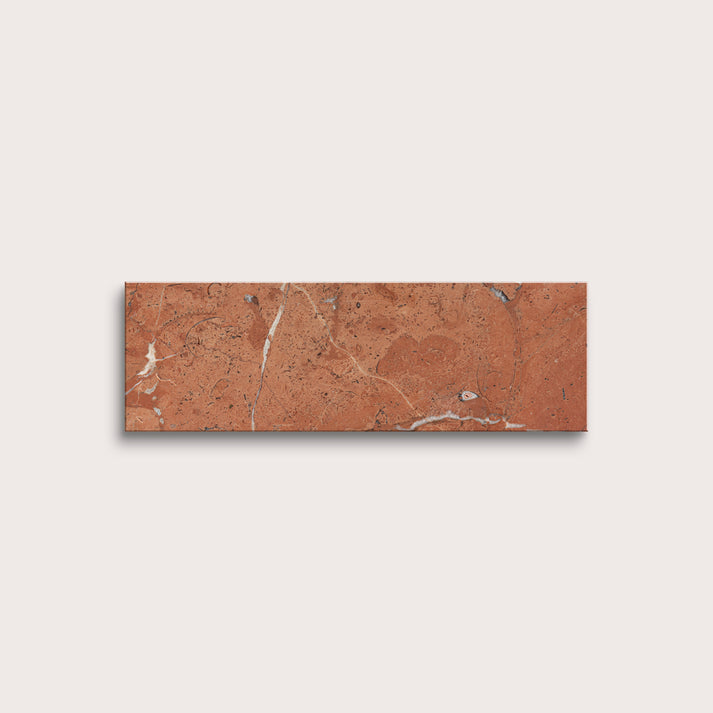 Rectangular brown tile with marble-like pattern on a light gray background