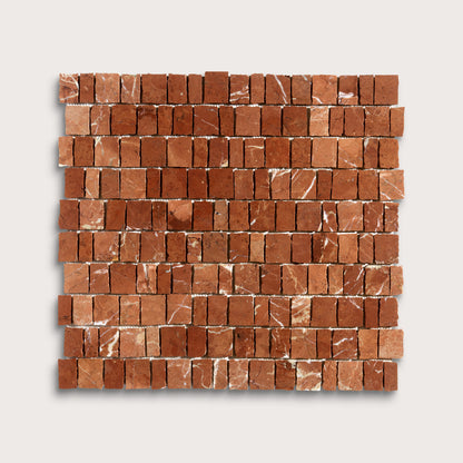A square sample of reddish-brown marble rectangular mosaic tiles with natural white veining, arranged in horizontal rows on a light gray background.