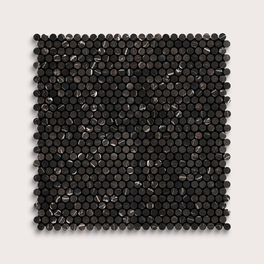 Square marble tile with black circular pattern on a light gray background