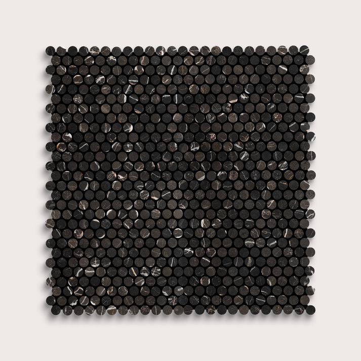 Square marble tile with black circular pattern on a light gray background