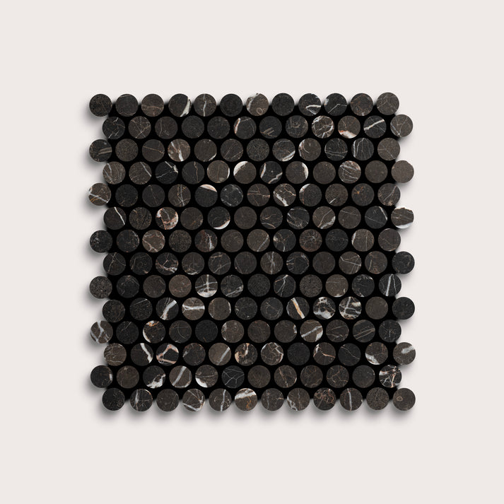 Square arrangement of black circular marble tiles on a light gray background