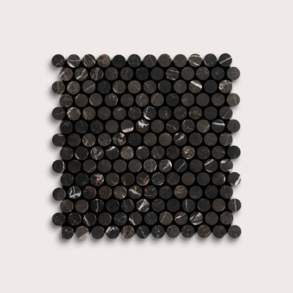 Square arrangement of black circular marble tiles on a light gray background