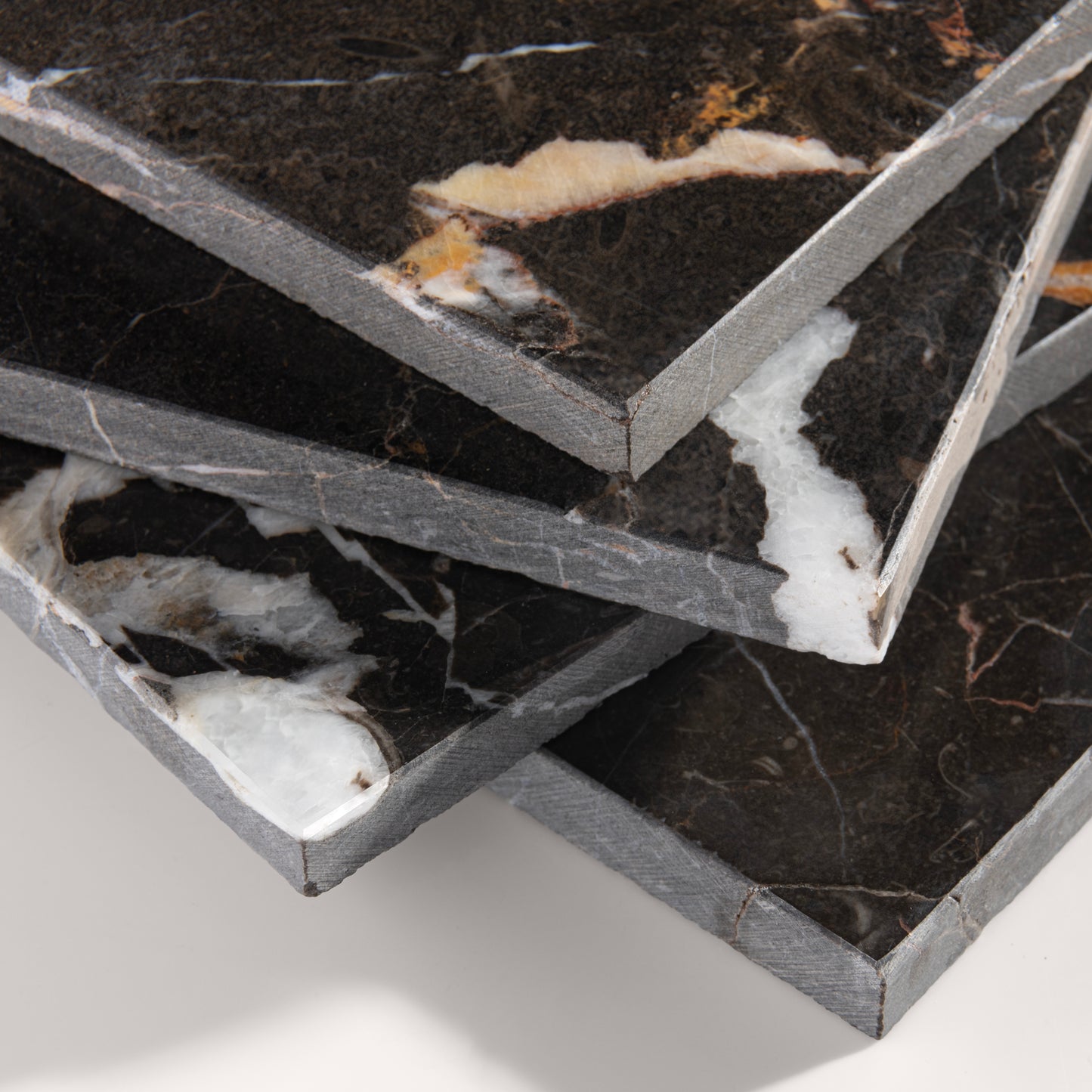 close up angle of brown marble tiles with visible veins on a white background