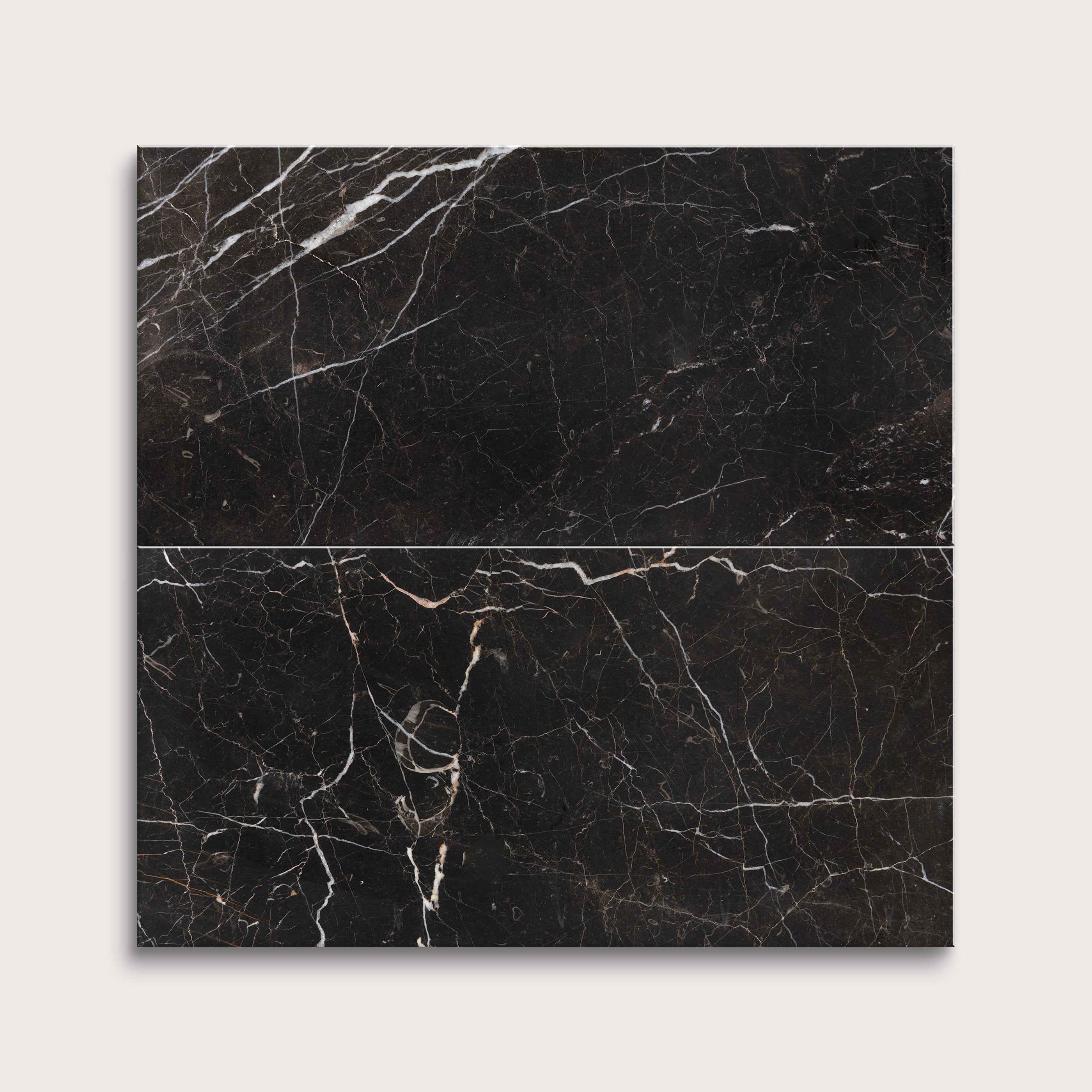 Brown marble tiles with white veins on a light gray background