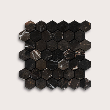 Hexagonal black marble mosaic tile on a light gray background