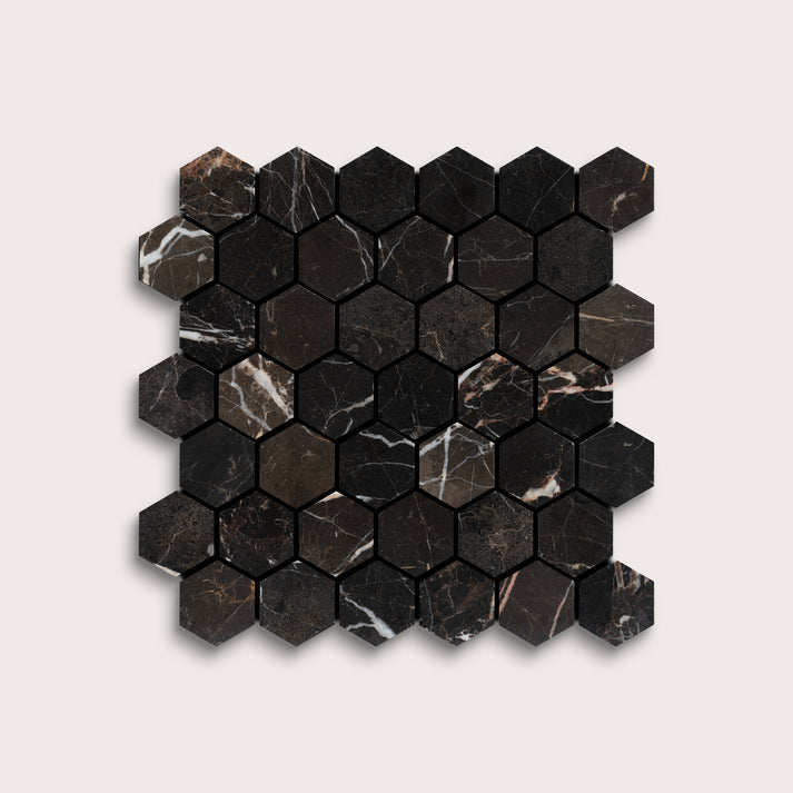 Hexagonal black marble mosaic tile on a light gray background
