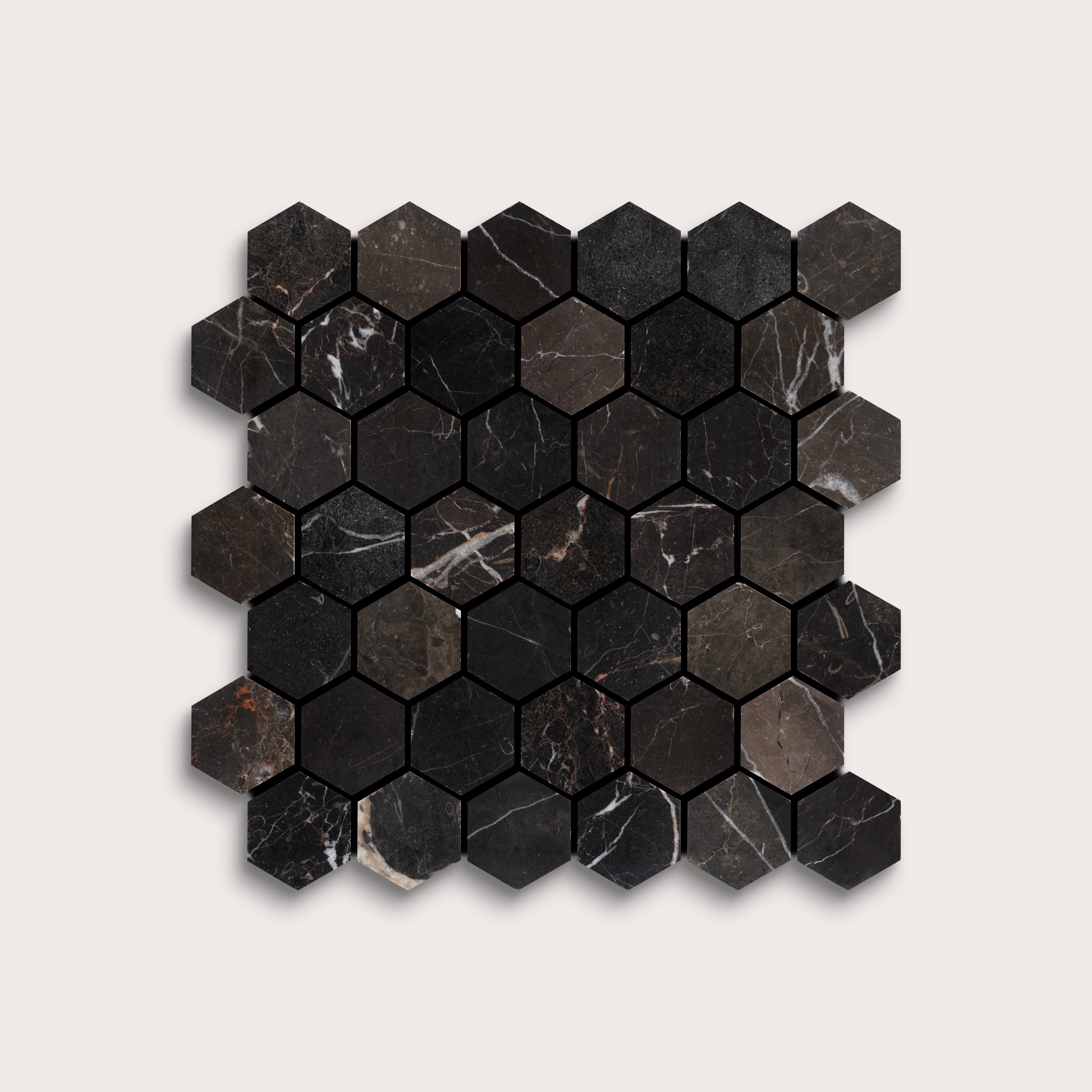 Hexagonal black marble mosaic tile on a light gray background