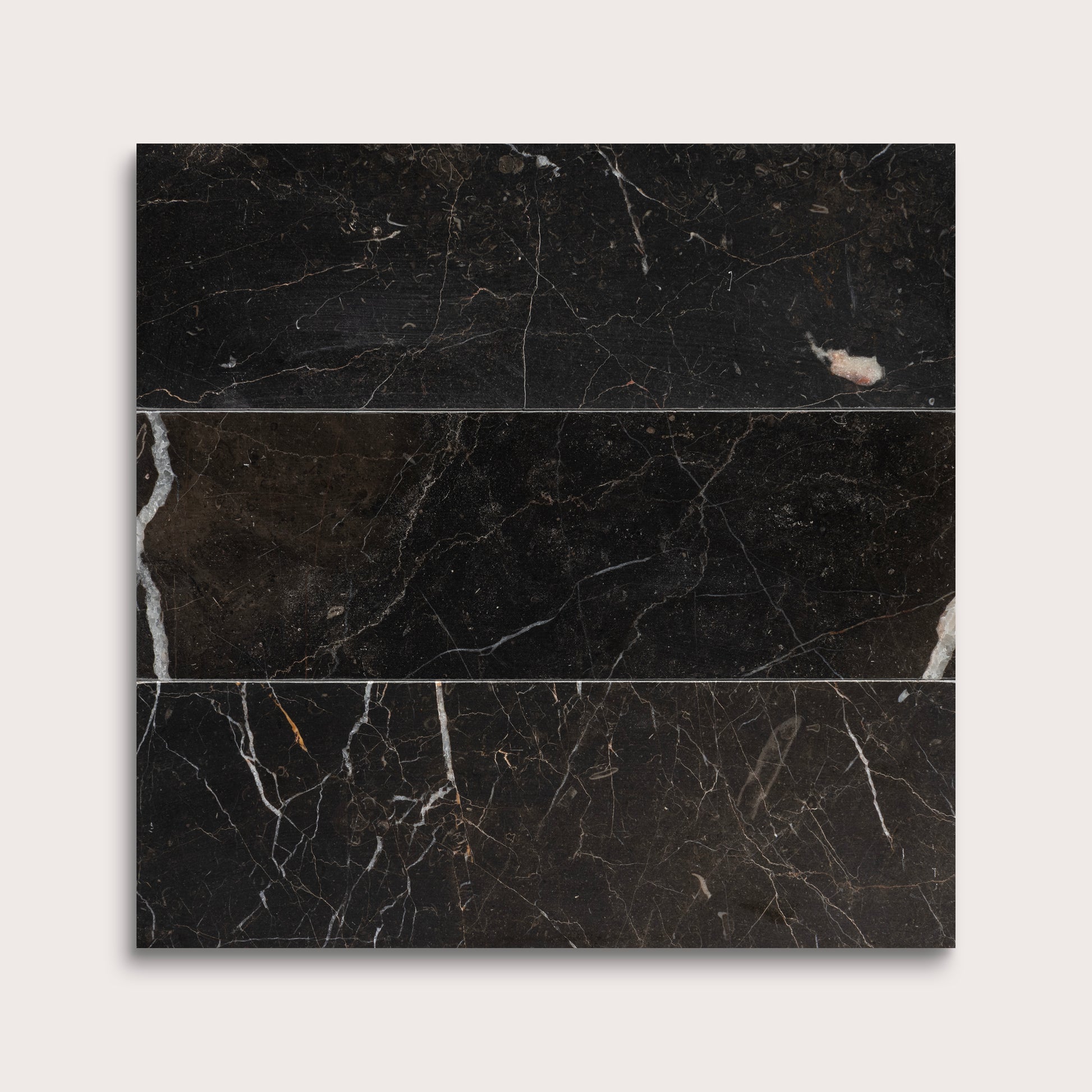 Brown marble tiles with visible veins on a white background