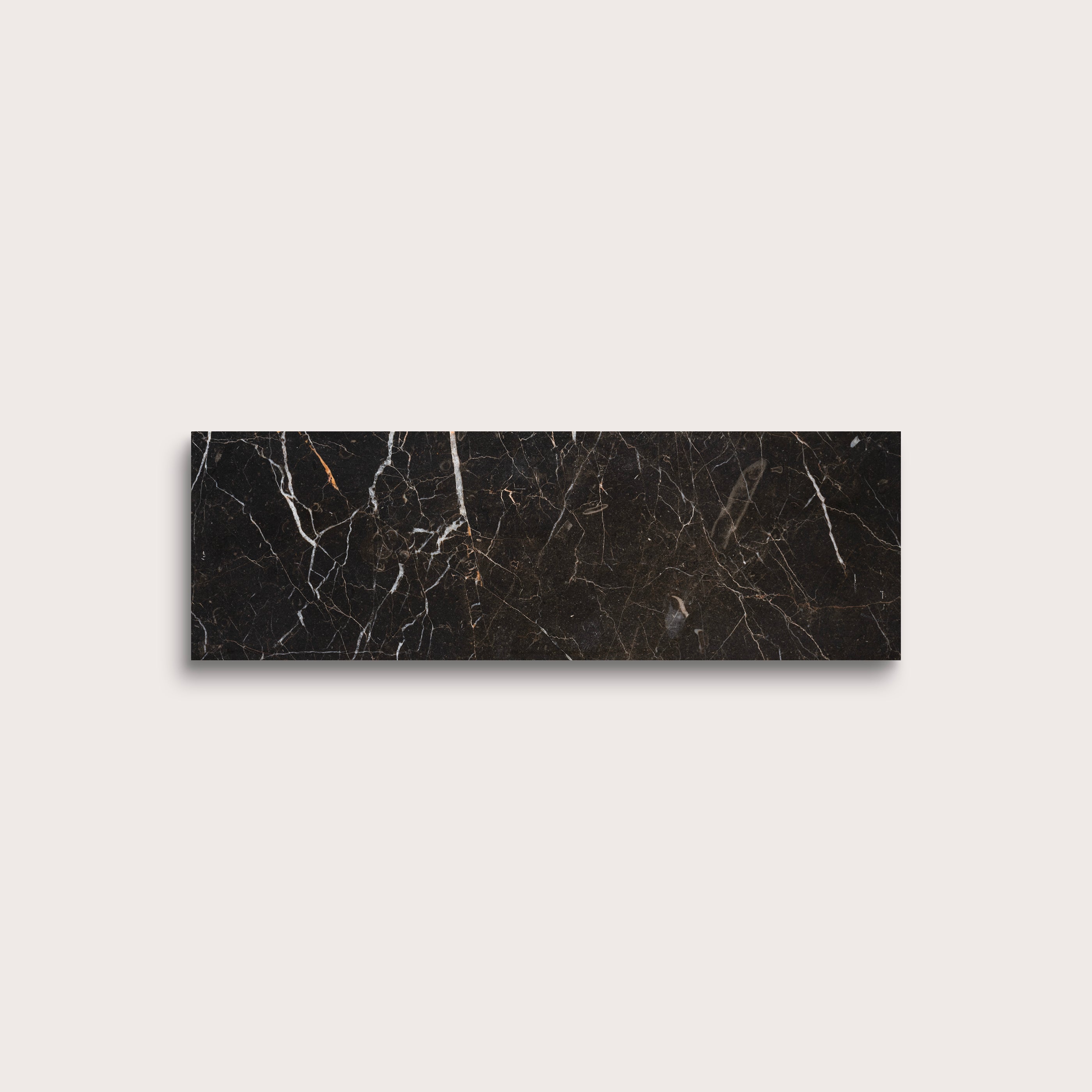 Brown marble tile with visible veins on a light gray background