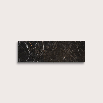 Brown marble tile with visible veins on a light gray background