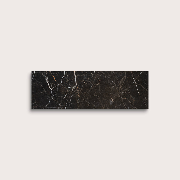 Brown marble tile with visible veins on a light gray background