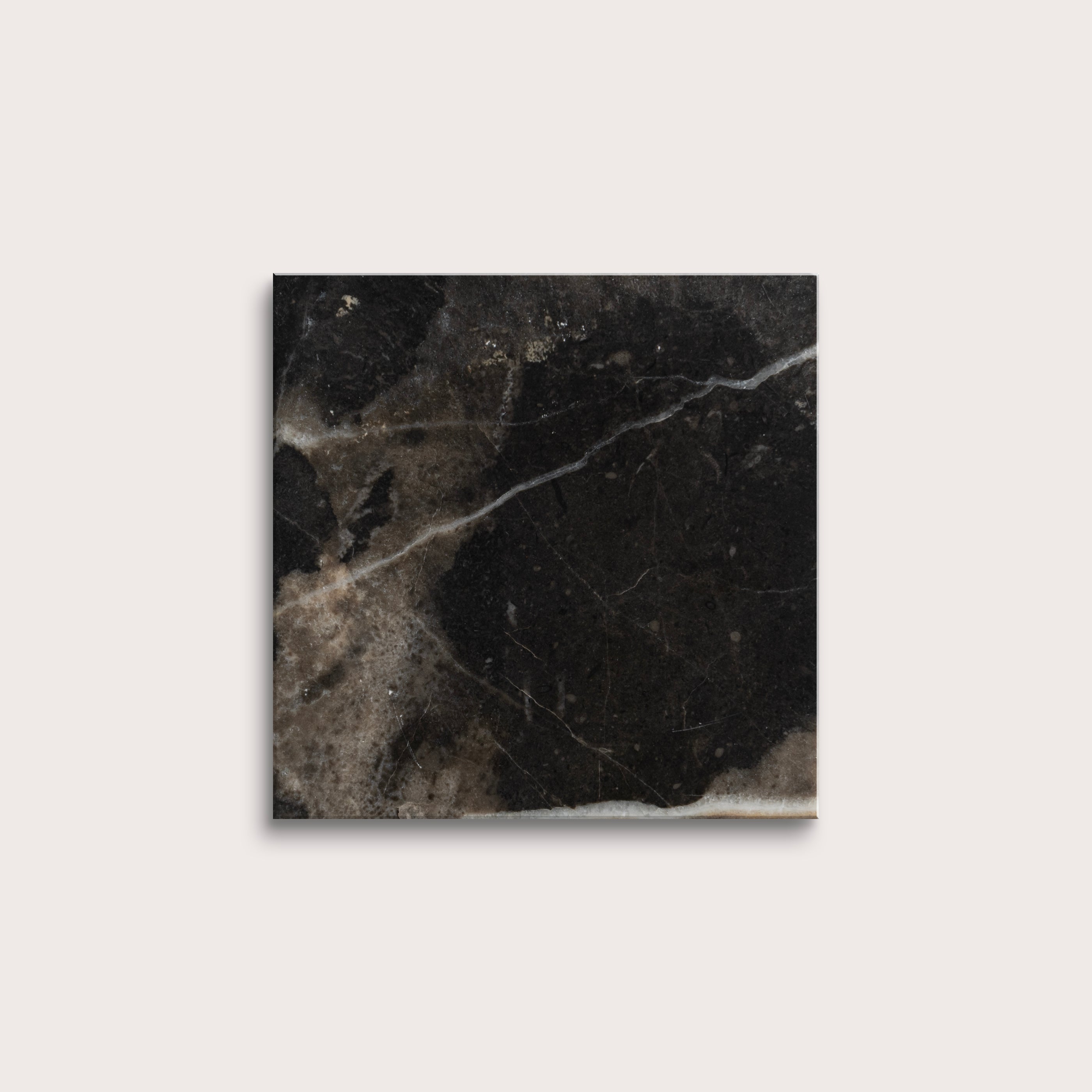 Square tile with black marble pattern on a light gray background