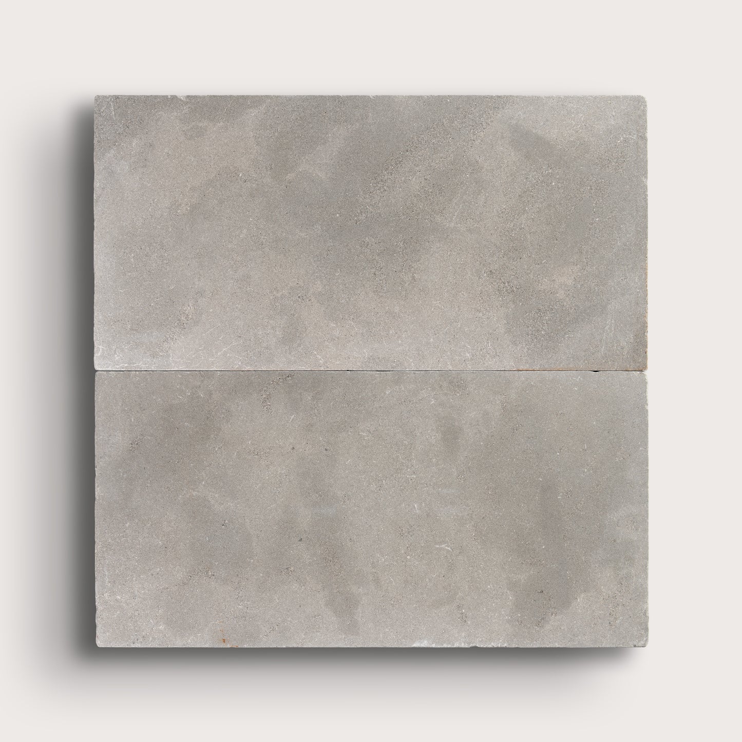 grey limestone rectangle tile in a grid pattern on light grey background