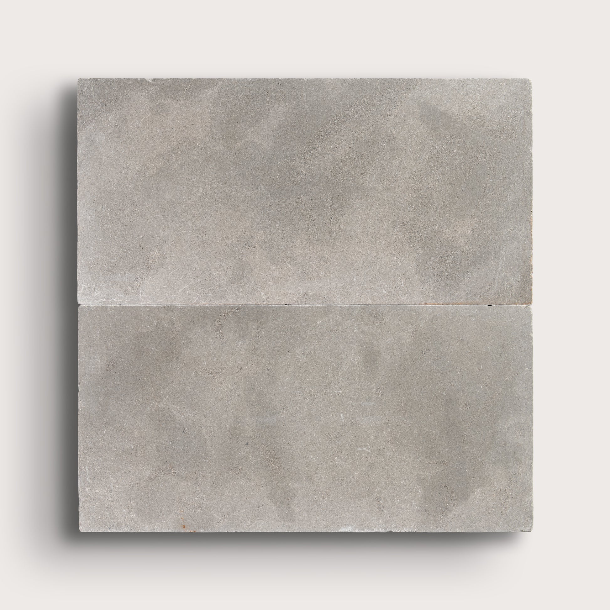 grey limestone rectangle tile in a grid pattern on light grey background