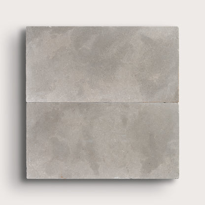 grey limestone rectangle tile in a grid pattern on light grey background
