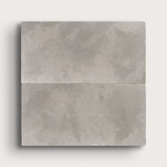 grey limestone rectangle tile in a grid pattern on light grey background