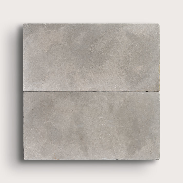 grey limestone rectangle tile in a grid pattern on light grey background