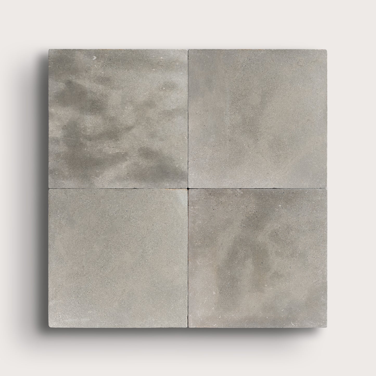 grey square limestone tiles in a grid pattern on a light grey background