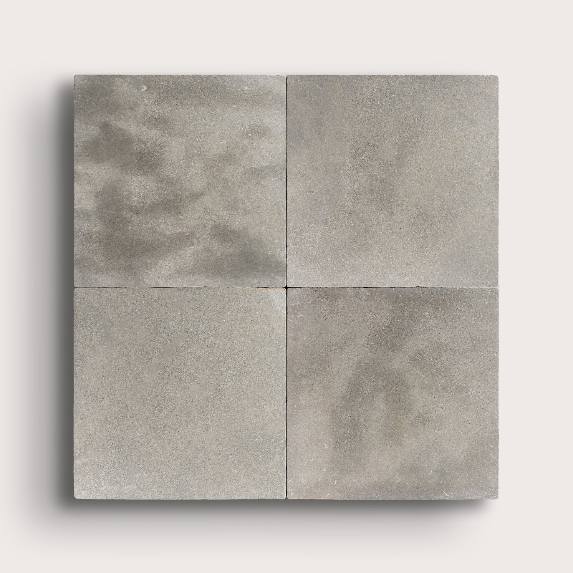 grey square limestone tiles in a grid pattern on a light grey background