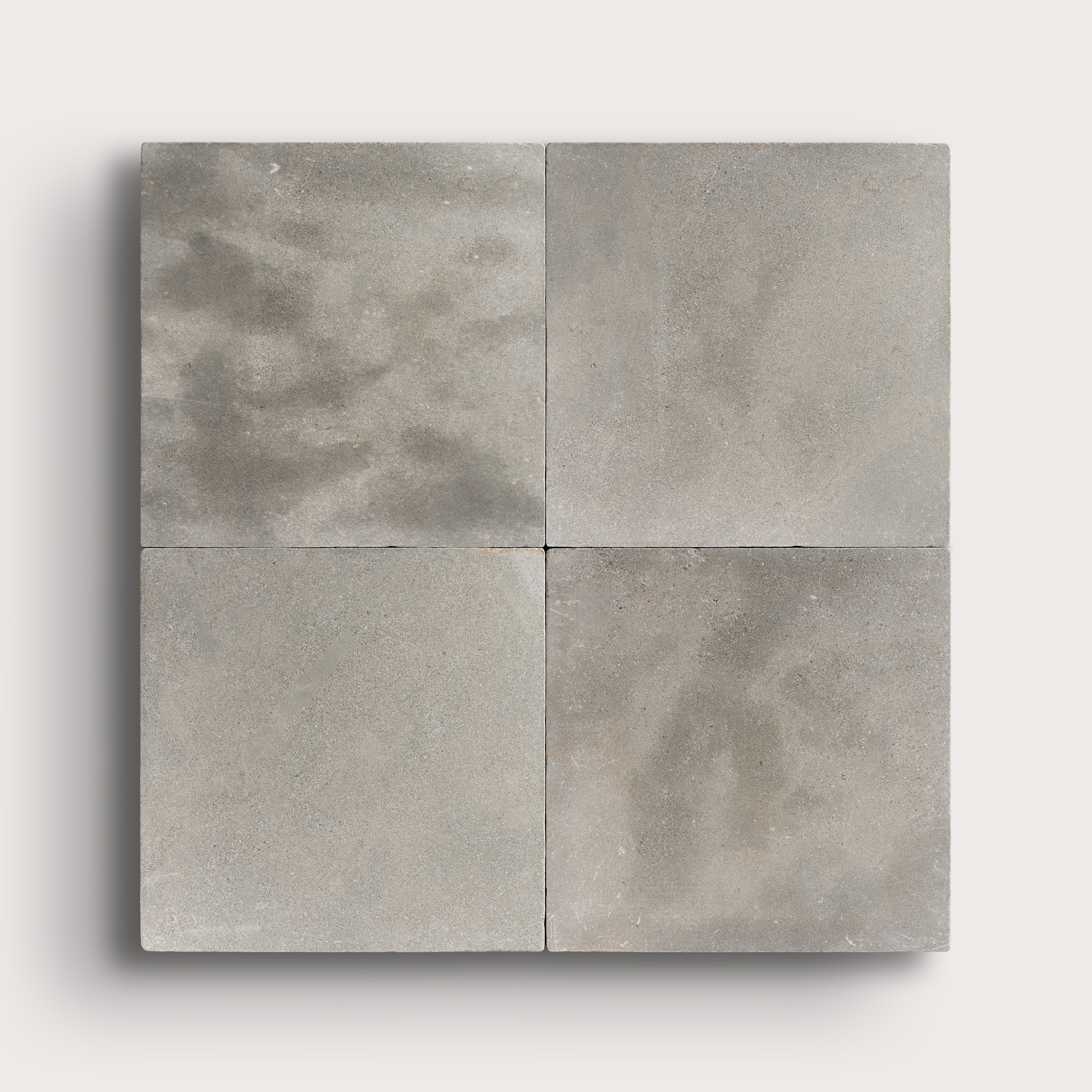 grey square limestone tiles in a grid pattern on a light grey background