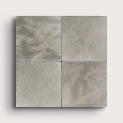 grey square limestone tiles in a grid pattern on a light grey background