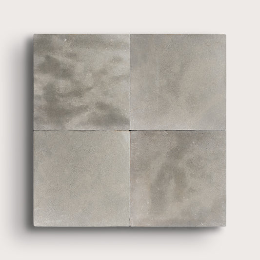 grey square limestone tiles in a grid pattern on a light grey background