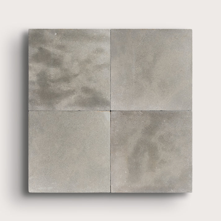 grey square limestone tiles in a grid pattern on a light grey background