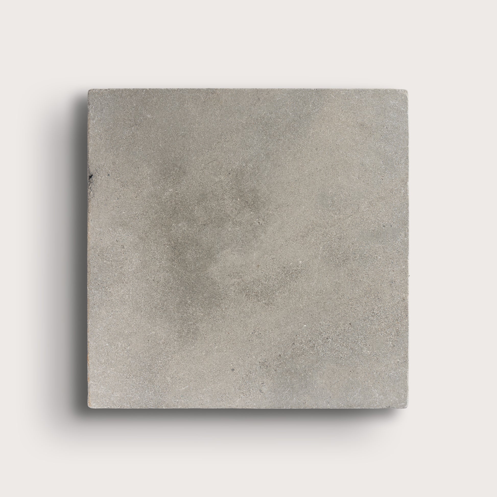 grey square limestone tiles on a light grey background