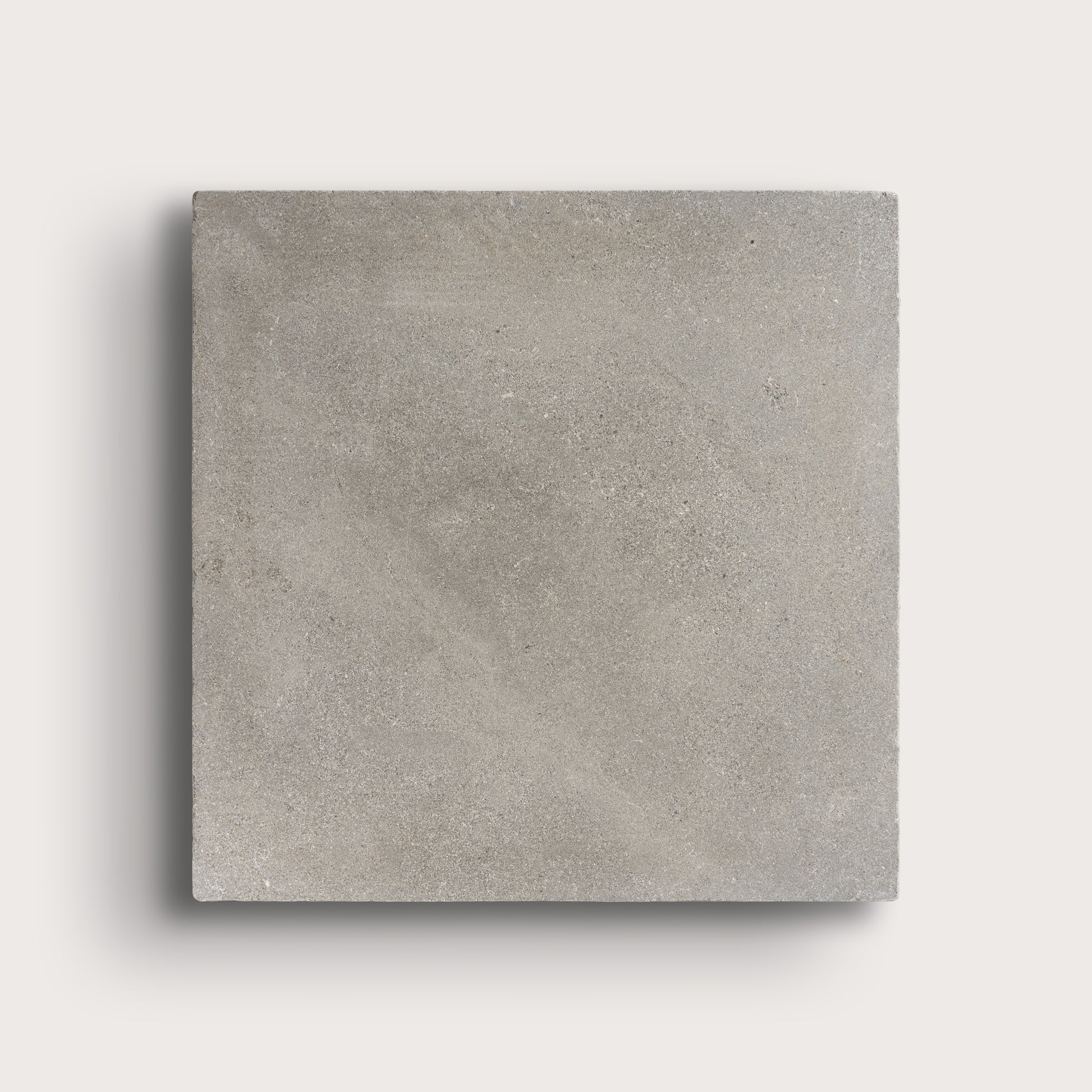 grey square limestone tiles on a light grey background