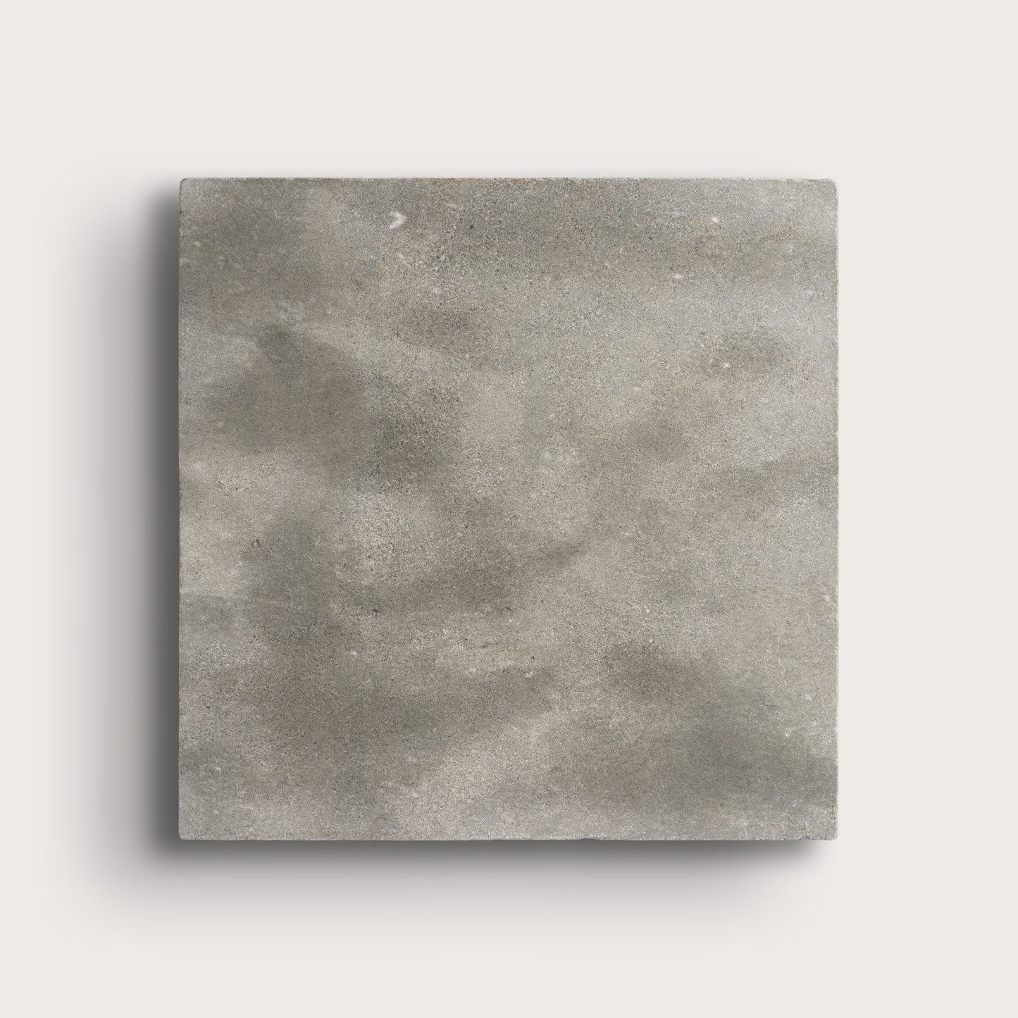 grey square limestone tiles on a light grey background