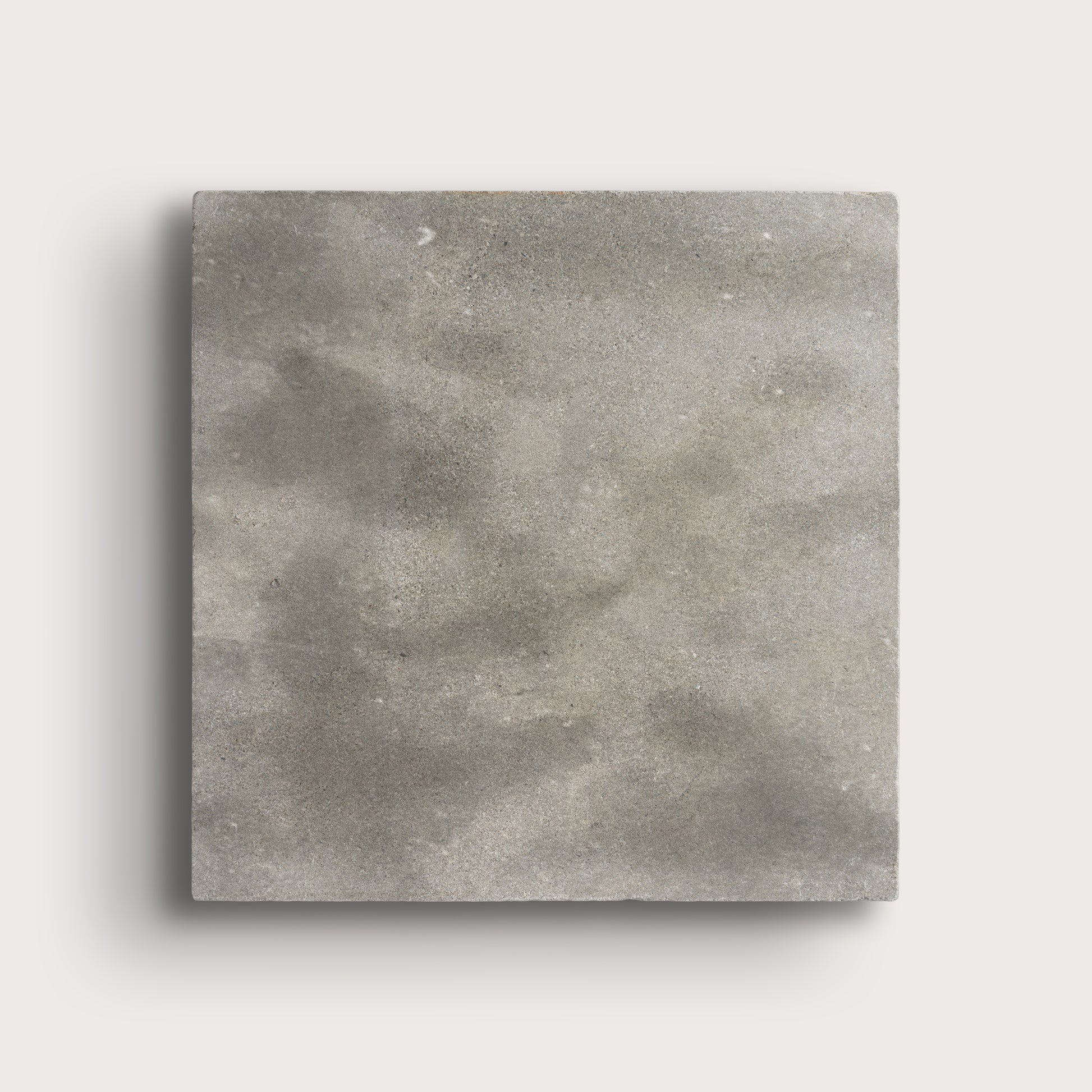 grey square limestone tiles on a light grey background