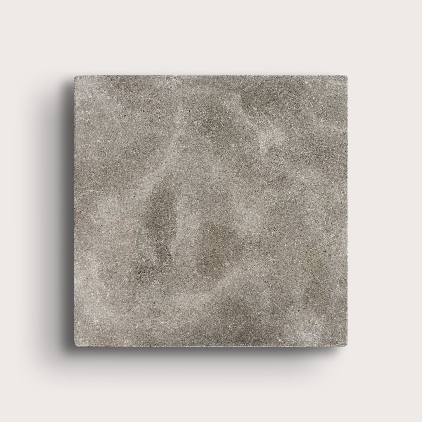 grey square limestone tiles on a light grey background