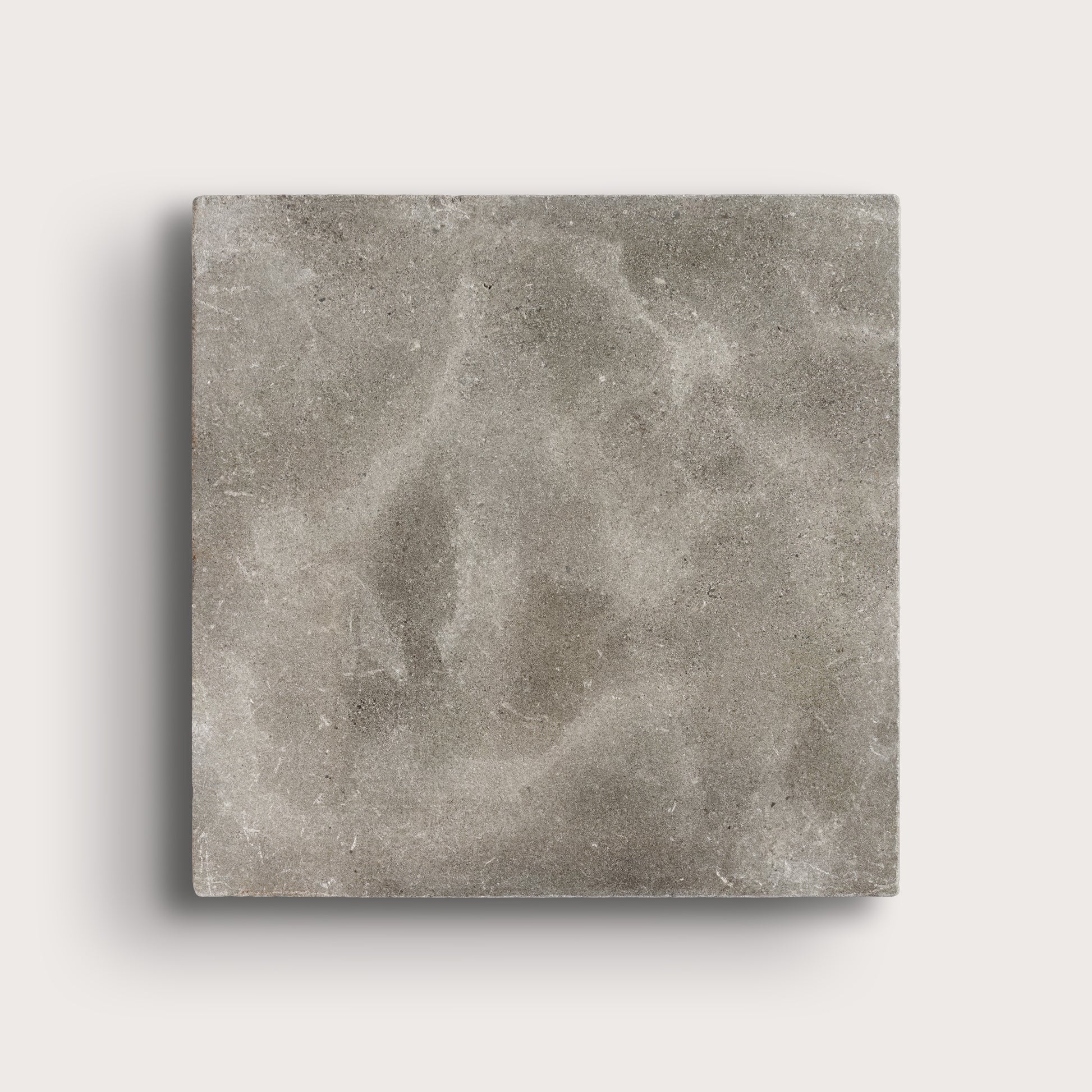 grey square limestone tiles on a light grey background